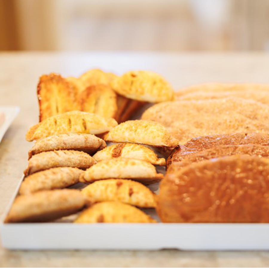 white tray of baked fritters and cookies